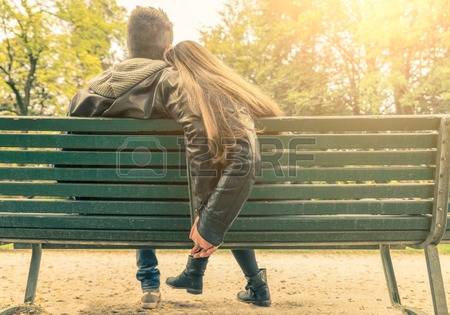 32762345-couple-on-a-bench-two-lovers-sitting-on-a-bench-in-a-park-and-holding-themselves-by-hands-concepts