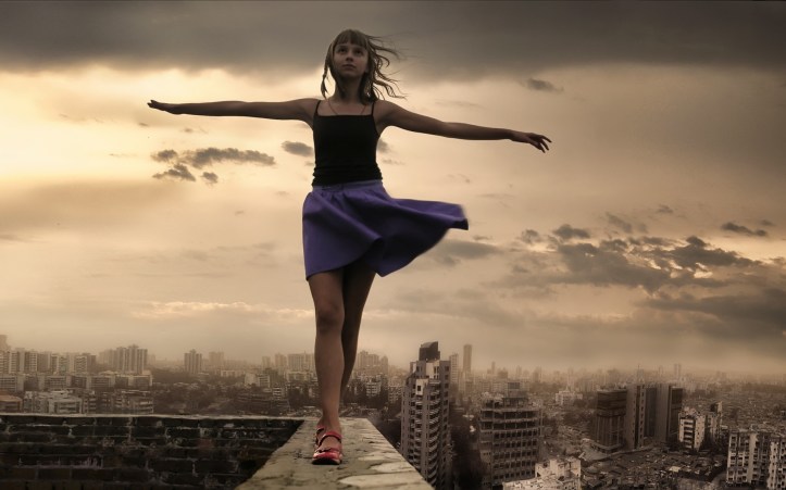 girl-walking-on-roof-edge
